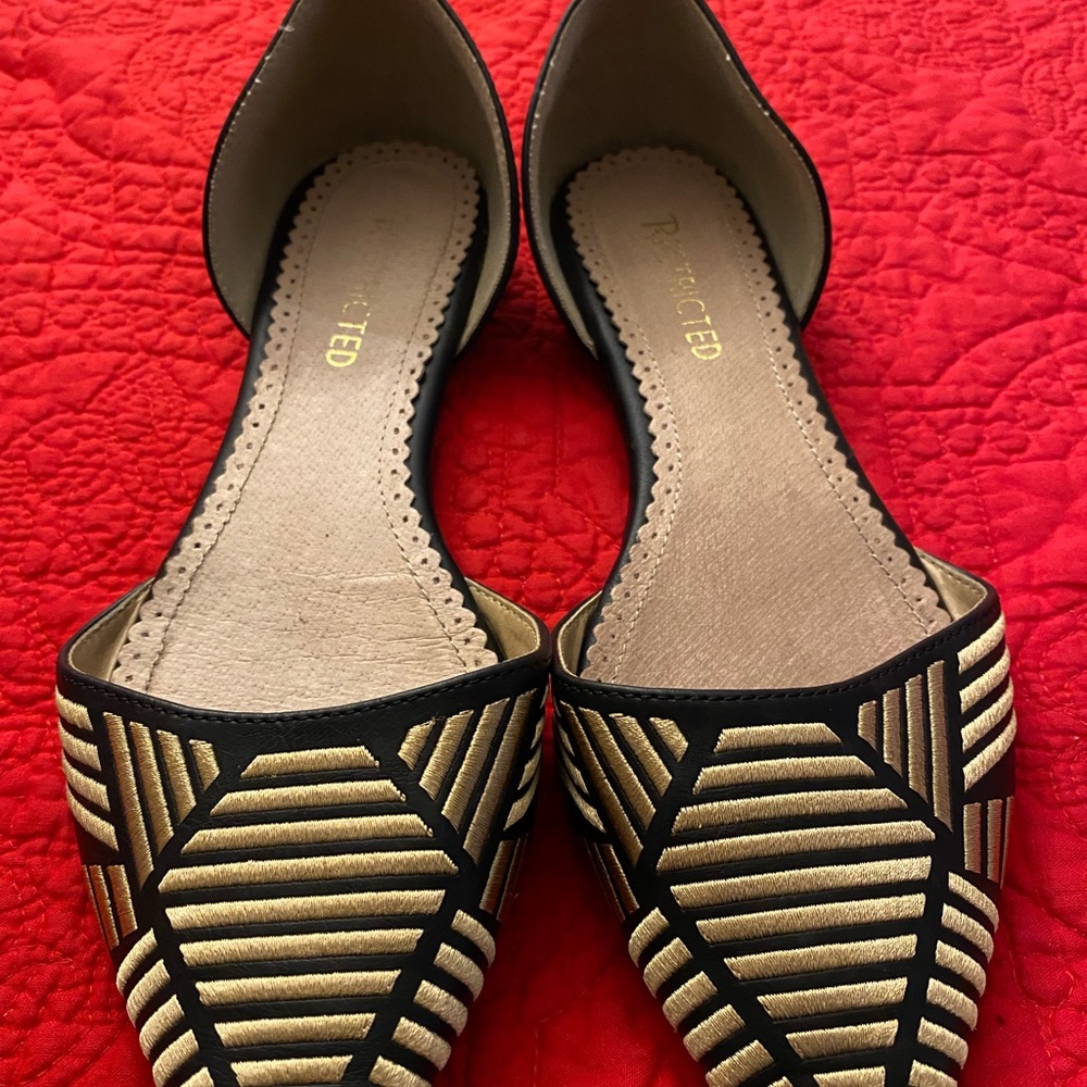 Restricted Black and Gold flats.